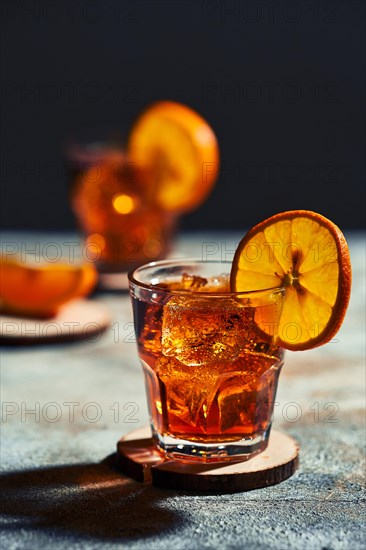 Cocktail old fashioned with hard light and harsh shadows