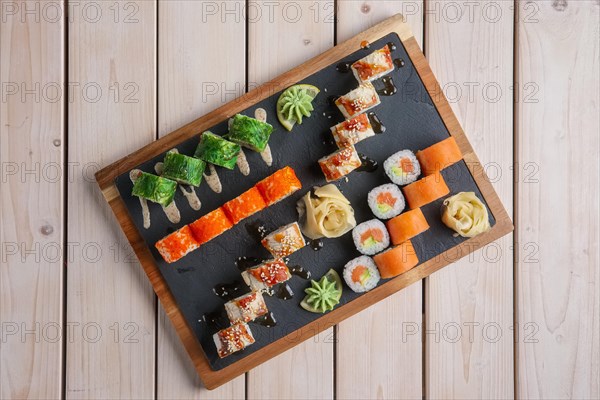 Big set of rolls served on stone plate