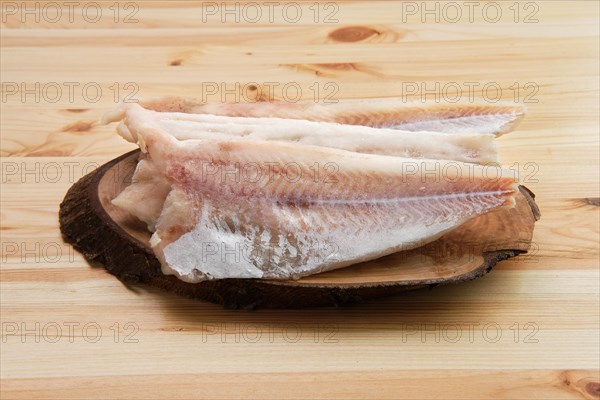 Frozen fillet of pangasius on wooden table