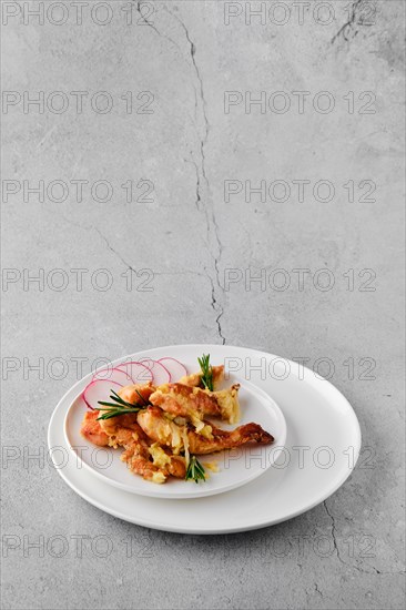 Plate with chicken stripes baked with cheese and onion