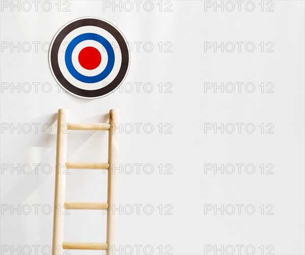 Front view target with wooden ladder copy space