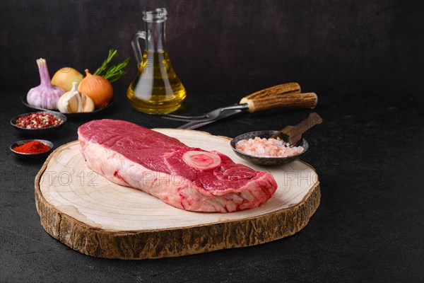 Raw chuck eye steak on kitchen table ready for cooking