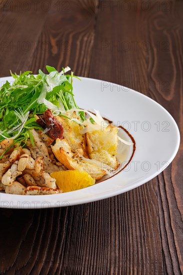 Closeup view of salad with fried chicken meat