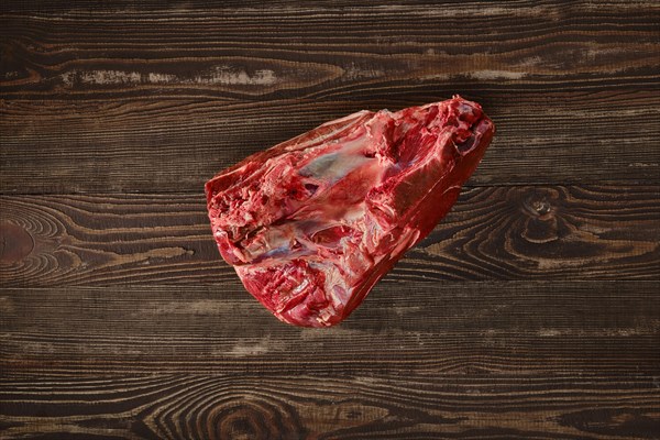 Raw fresh beef shank cross-cut on wooden background