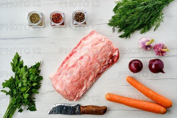 Raw fresh pork collar joint meat on wooden background with spice