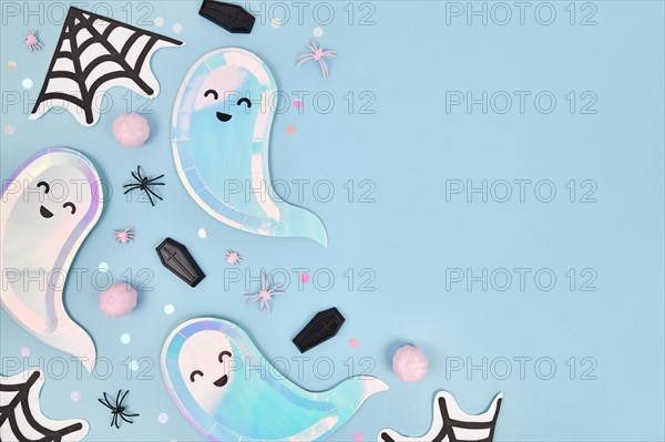 Cute pastel colored Halloween party flat lay with ghost shaped plates