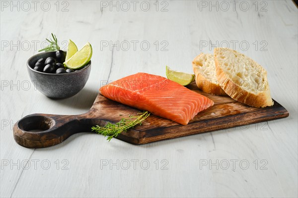 Piece of fresh salmon steak with ciabatta and spicy herb sauce