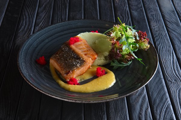 Fried salmon with mashed potato mixed with wasabi and decorated with flying fish roe