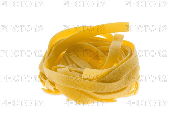 Nest noodles isolated on white background. Italian tagliatelle with egg