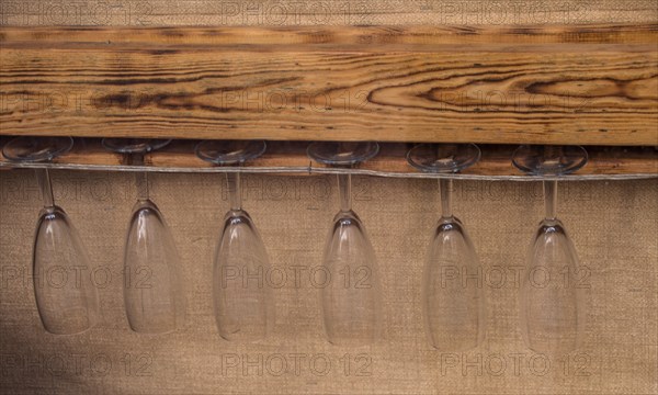 Glass cups hanging from a wooden platform in the view