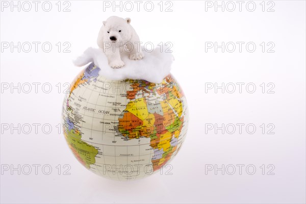 Polar bear on globe on a white background