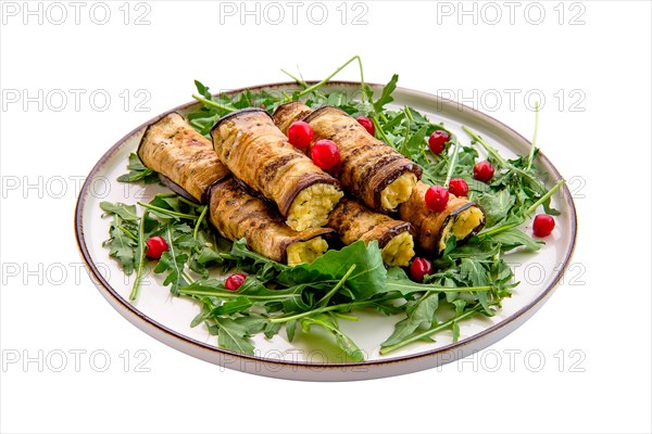 Eggplant rolls stuffed with soft cheese and garlic decorated with arugula and cranberry