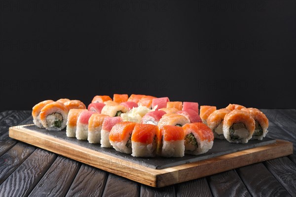 Big set of rolls served on stone plate. Layout for menu