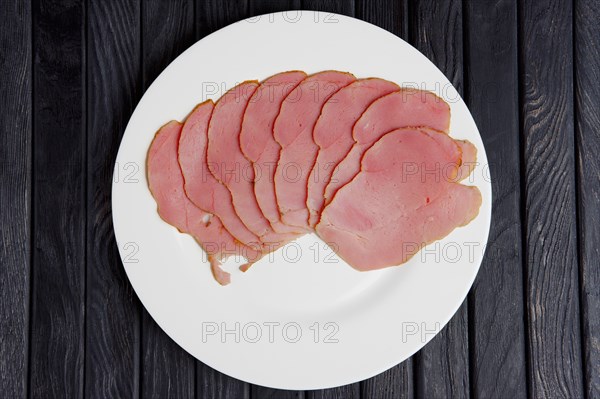 Top view of plate with slices of fresh ham