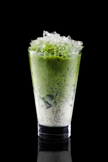 Iced matcha tea and crushed ice isolated on black background