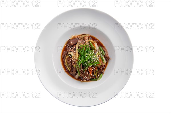 Top view of wok with beef and green beans isolated on white background