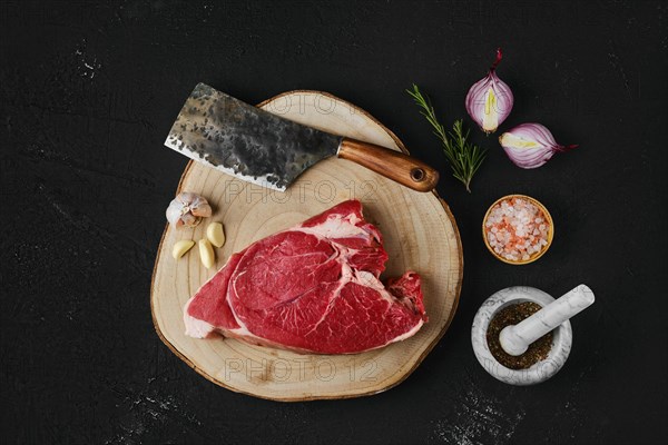 Overhead view of raw top round roast beef steak on wooden cutting board