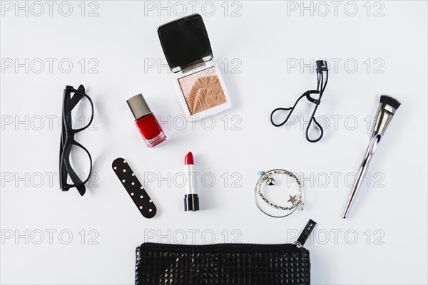 Glasses cosmetics near stylish makeup bag
