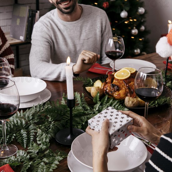 Hands holding gift box christmas dinner