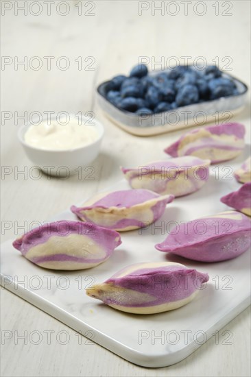 Frozen pierogi with blueberry and sour cream