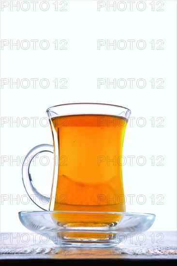 Low angle photo of cup with hot tea with copy space on white background