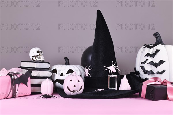 Pink and white Halloween decor with black and white pumpkins