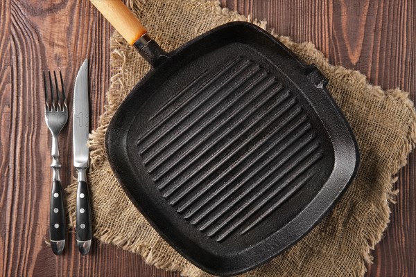 Cast-iron pan top view on wooden background