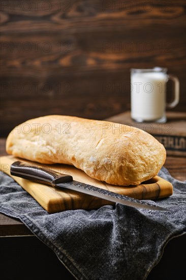 Freshly baked ciabatta on brown wooden table