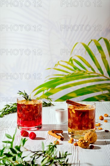 Refreshing espresso and tonic summer drinks on white table under hard sulight