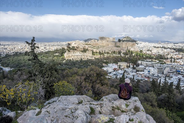 Tourist sitting on rock