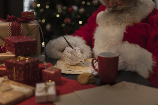 Close up santa claus writing letter