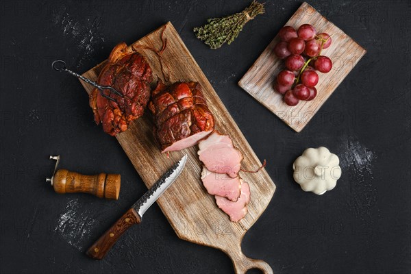 Air dried pork ham on wooden cutting board