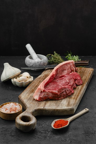 Raw beef ribeye lip on with skin on wooden cutting board