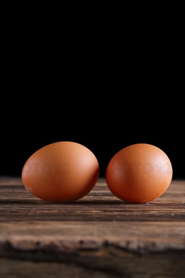 Two eggs on wooden table