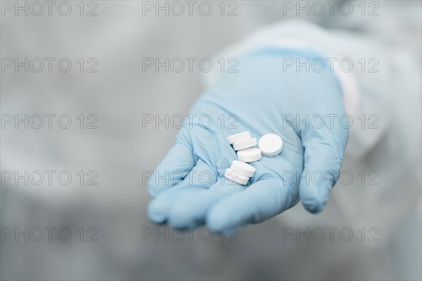 Close up hand holding pills