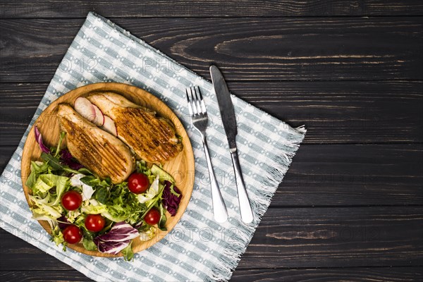 Utensils near roasted chicken and salad. Resolution and high quality beautiful photo