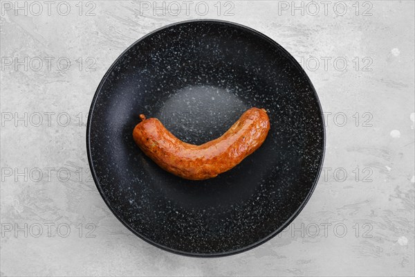 Fried bavarian sausage on a plate