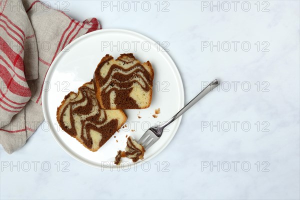 Two pieces of marble cake on plate