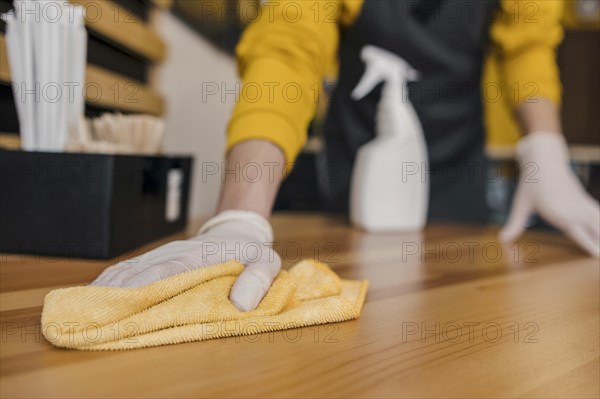 Front view barista cleaning table