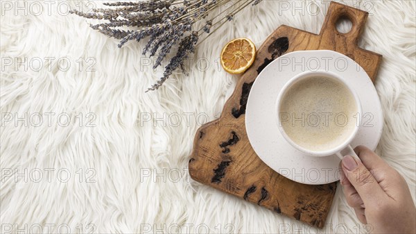 Top view person holding cup coffee with lavender dried citrus. Resolution and high quality beautiful photo