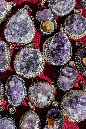 Raw violet amethyst rock as a necklace