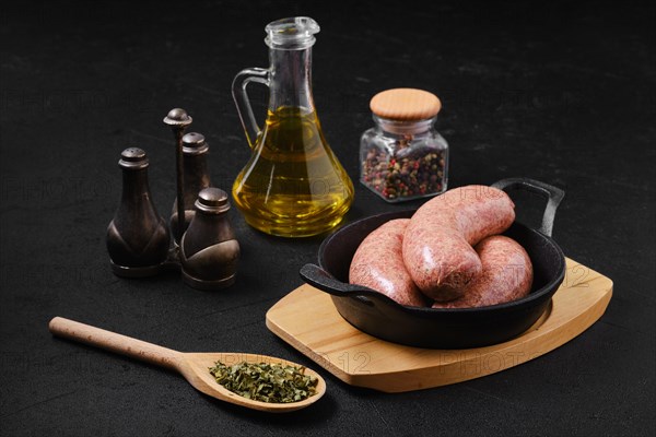 Homemade classic raw beef sausage in cast iron skillet