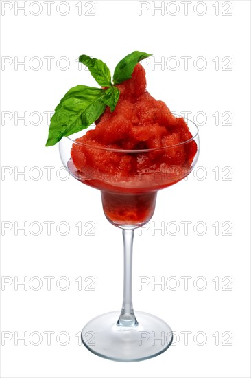Watermelon smoothie in wide glass decorated with spinach leaves isolated on white
