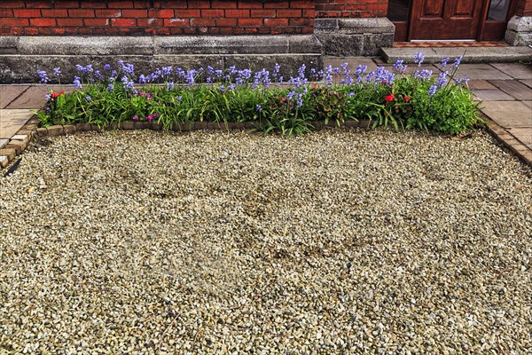 Dull front garden with gravel and planting in front of the house