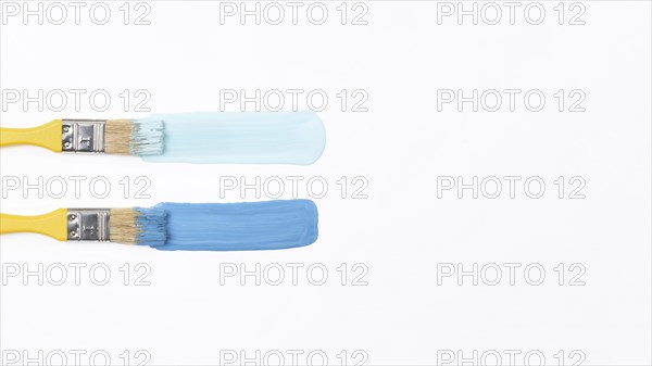 Top view yellow brushes with blue paint. Resolution and high quality beautiful photo