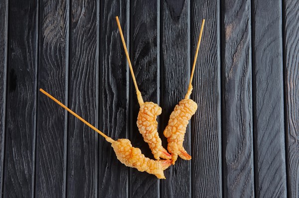 Appetizer for reception. Deep-fried shrimp on skewer