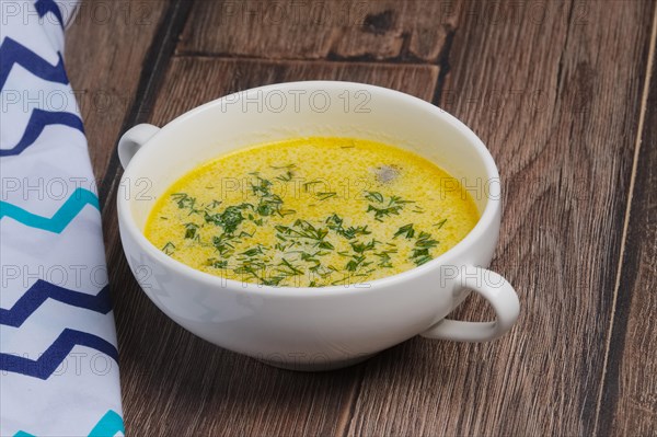 Plate of mushroom soup on wooden table