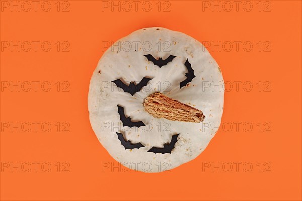 Top view of white Japanese Hokkaido quash with bats on orange background