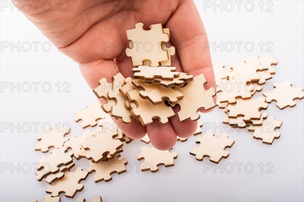 Hand holding piece of jigsaw puzzle as problem solution concept