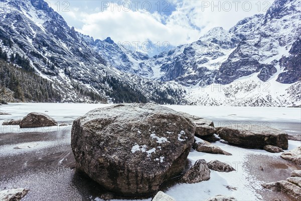 Rocks lake with mountains winter